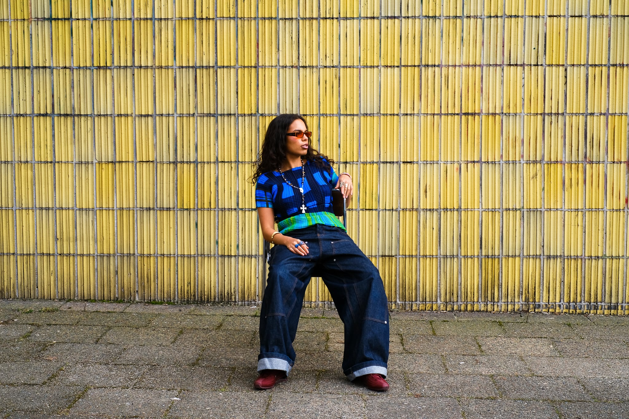 MARÍAJOSÉ against a yellow bamboo wall in Berlin